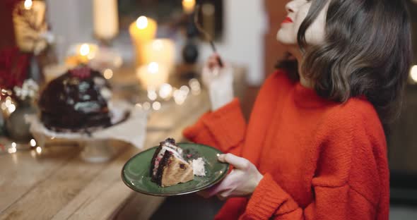 Woman Eating Chocolate Cake During a Winter Holidays