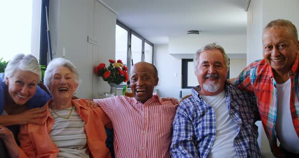 Happy senior friends having fun while relaxing on sofa 4k