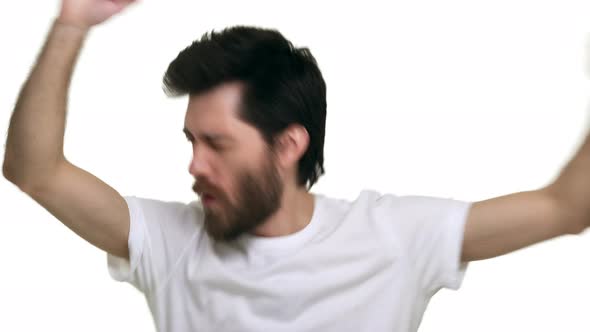 Young Relaxed Loose Man Singing Dancing to Club Music Waving Hands on White Background