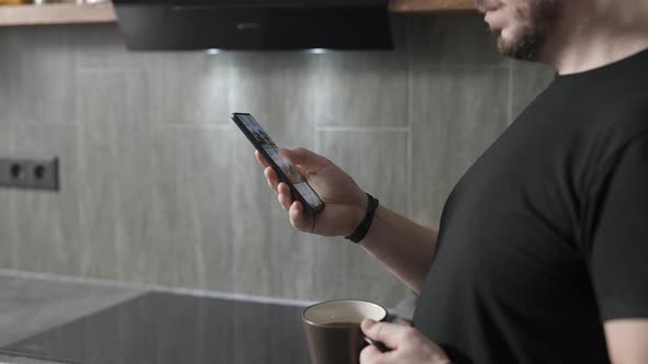 A Man Chooses a New Home for Himself Through an Application on a Smartphone