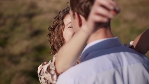 Man Embracing Woman, Hugging and Smiling To Each Other