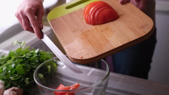 Closeup of Woman Slicing Tomatoes on Wooden Cutting Board  Preparing Ingredient for Meal