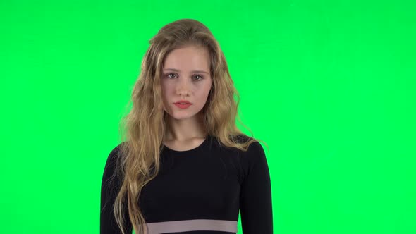 Blonde Girl Posing at the Camera. Green Screen