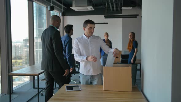 Entrepreneur Unpack Boxes and Look at Road Drawings in Modern Office