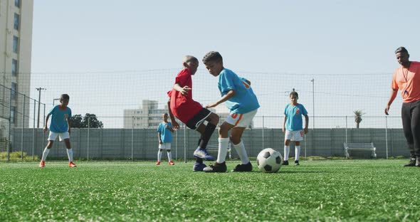 Soccer kids playing in a sunny day