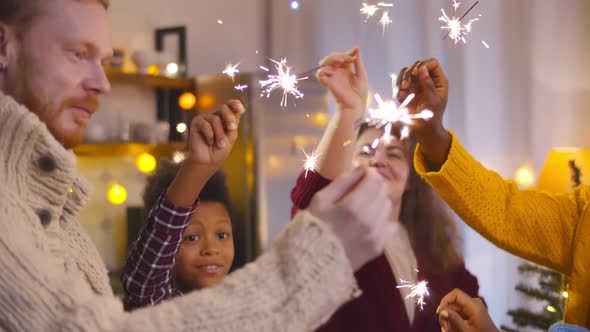 Multiethnic Friends Celebrating Christmas with Bengal Lights