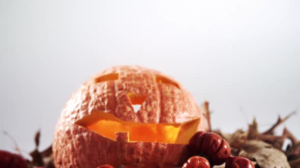 Halloween pumpkin with maple leaf against white background 4k