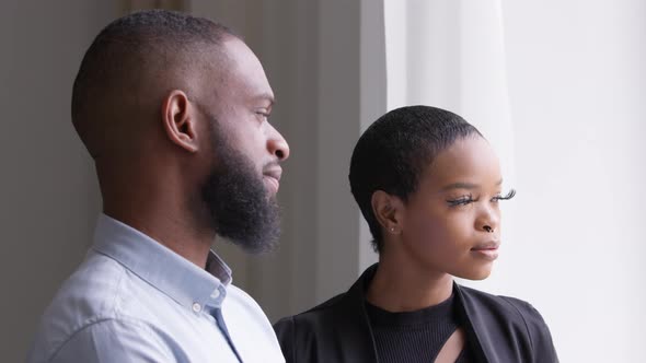 Two Business Partners Colleagues Adult African Man and Young Woman Standing in Office Looking Out