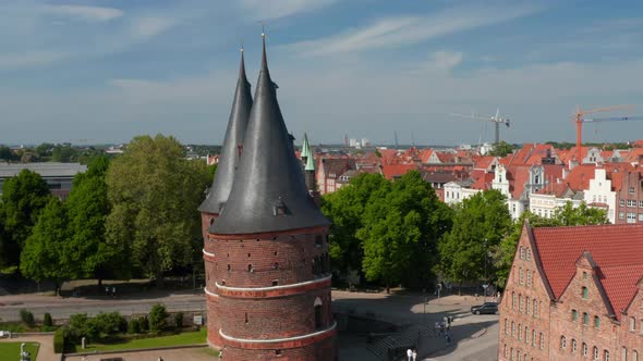 Aerial Orbit Shot Around Holstentor Medieval Town Gate