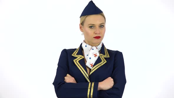 A Young Beautiful Stewardess Frowns and Shakes Her Head at the Camera - White Screen Studio