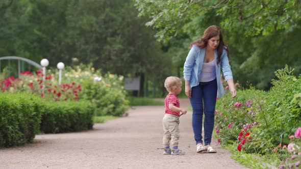 Mother and Child Walking in the Park in Summer Happy 1