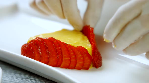 Hands Touch Slices of Strawberry.