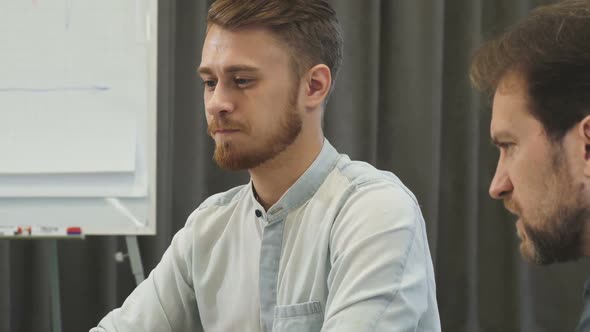 Cropped Shot of Two Male Business Colleagues Working Together at the Office