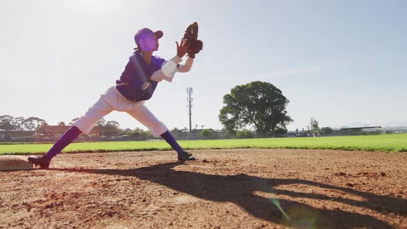 Diverse female baseball players, fielder on base catching out a running hitter on baseball field