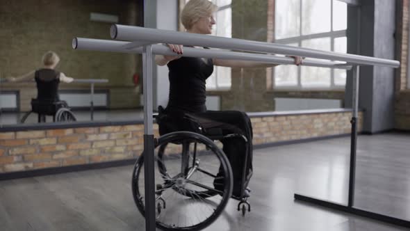 Disabled Woman Dancer Exercising at Ballet Barre