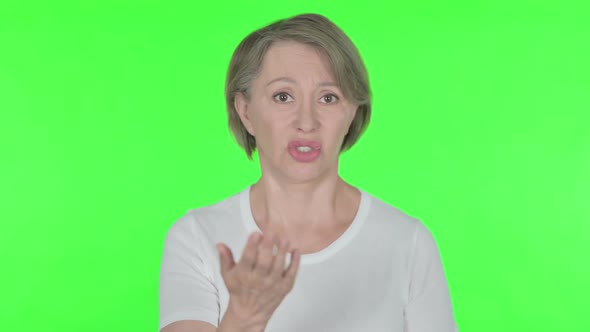 Angry Old Woman Arguing on Green Background