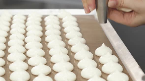 Cropped  of a Confectioner Using Pastry Bag Preparing Meringue Cookies