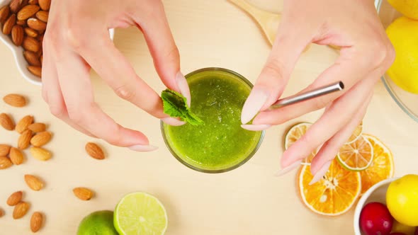 Mixing with Straw Detox Smoothie Made From Vegetables and Greenery Closeup