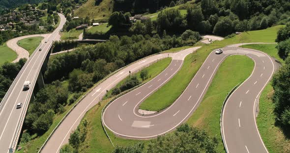 Aerial View of Cars Driving on Winding Serpentine Road, Switzerland