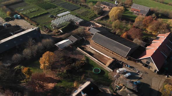 Aerial view of behind a biological dynamic farm in The Netherlands with a diversity of buildings, ba