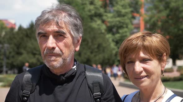 Mature tourists smiling and looking at the camera