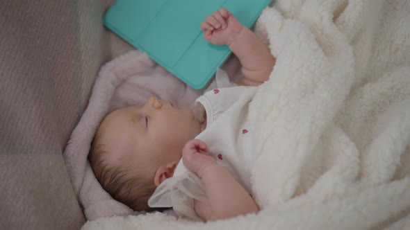 Top View Sleeping Newborn Caucasian Baby Lying on Soft Bed with Tablet