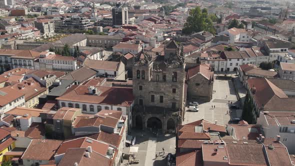 Aerial parallax motion Old Stone Cathedral, Surrounded by red rooftops - Braga City Centre