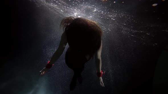 Mysterious Brunette Woman Underwater Keeping Afloat Under Water Surface