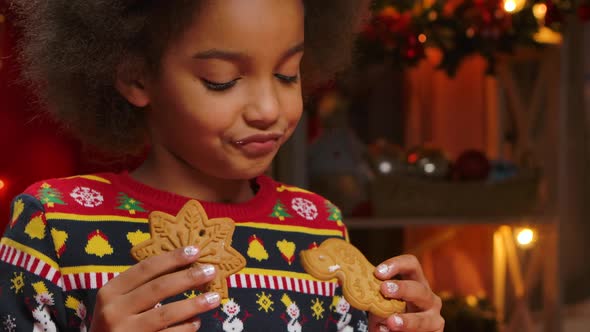 Cute African American Girl Is Enjoying the Traditional Christmas Cookies