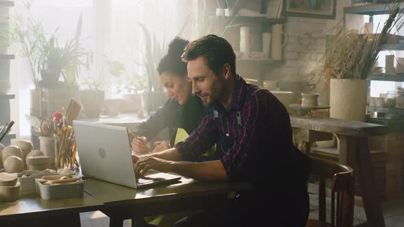 Woman and Man Work Together In Pottery