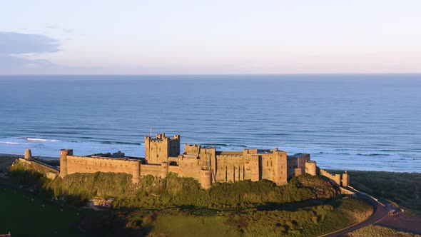 Sunset aerial drone shot of Bamburgh Castle in Northumberland, UK