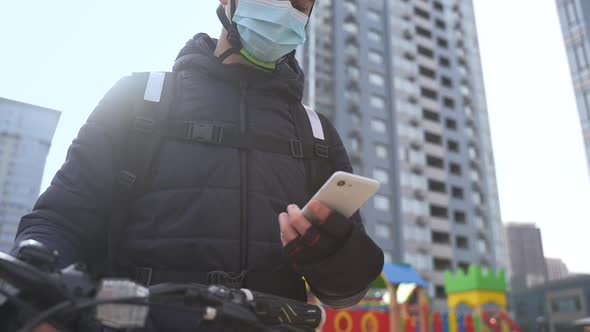Delivery Man in Face Mask Taking Order on Phone