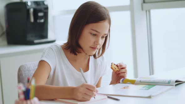 Serious handsome girl doing homework