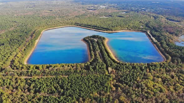 Aerial lake in flying a drone over the lake landscape and green forest