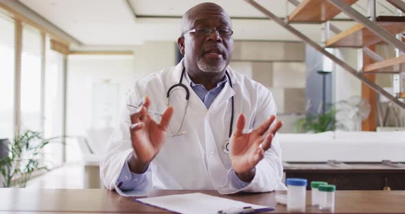 African american senior male doctor making video call consultation