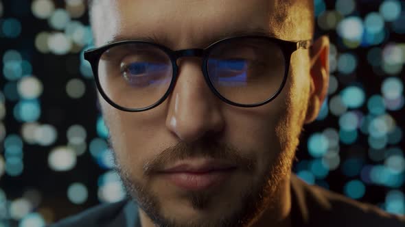 Close-up portrait of a young man working at the computer.