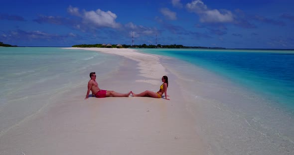 Young people married on vacation live the dream on beach on white sand background 4K