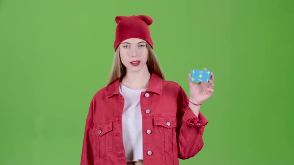 Girl Raises a Blue Card and Shows a Thumbs Up and Shows Ok. Green Screen. Slow Motion