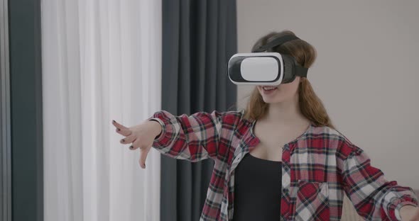 Young Girl in VR Glasses at Home