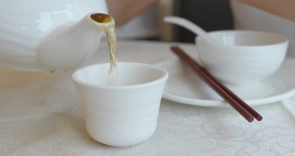 Pouring hot tea in chinese restaurant 