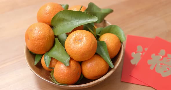 Citrus with chinese red packet word means luck