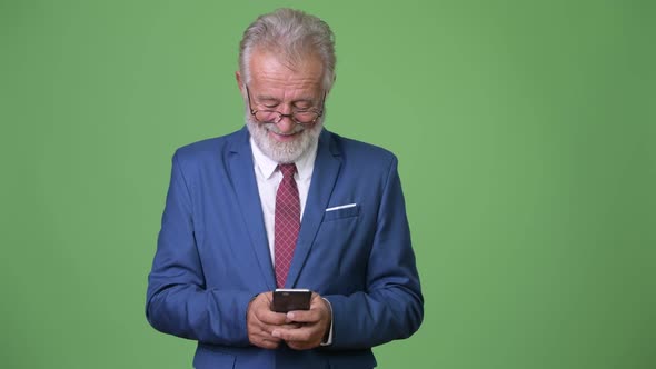 Handsome Senior Bearded Businessman Against Green Background