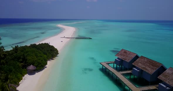 Tropical drone travel shot of a sunshine white sandy paradise beach and turquoise sea background in 