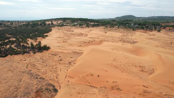 aerial top down of dry arid desert landscape surrounded by trees in Mui Ne Vietnam