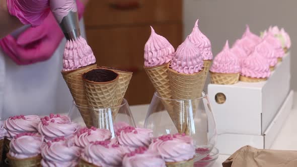 A Woman Fills Waffle Cones With Marshmallows. With A Pastry Bag. Close Up.