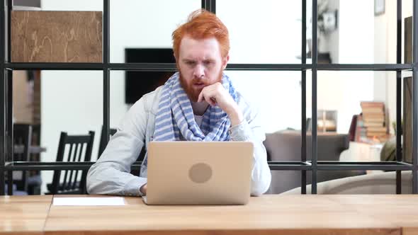 Pensive Man Working on Laptop in Office, Thinking