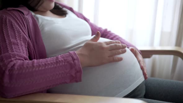 Happy Pregnant Woman and Expecting Baby at Home