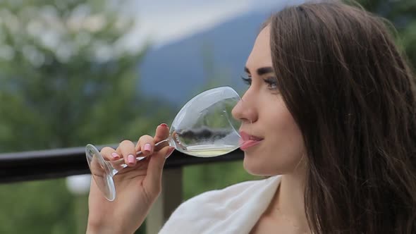 the Girl Drinks White Wine Sexy Young Woman with Glass of Wine