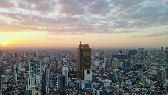 Golden Tower 42 Surrounded By High rise Buildings At Sunset In Phnom Penh, Cambodia. - aerial