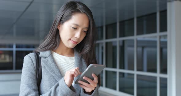 Woman use of mobile phone in city